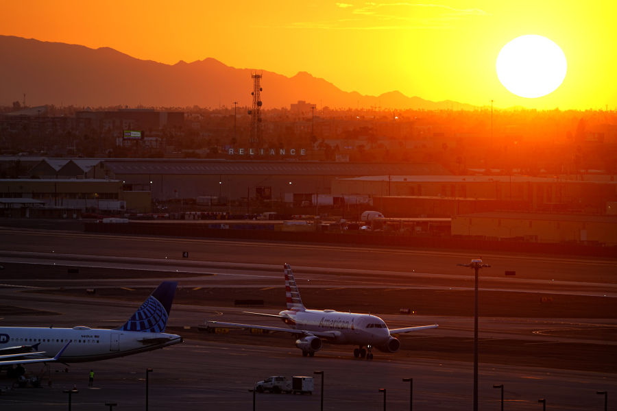 A jet arrives at sunset at Sky Harbor International Airport, Monday, July 10, 2023, in Phoenix. Phoenix is the epicenter of what may turn out to be an unprecedented extreme heat wave around the Southwest. The high temperature in the desert city has been at least 110 degrees for 11 consecutive days. Eighteen days was the longest stretch, according to the National Weather Service.