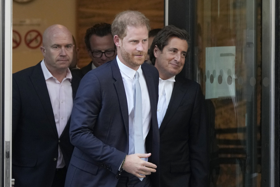 FILE- Prince Harry, centre, and David Sherborne, Prince Harry's lead lawyer, right, leave the High Court after giving evidence in London, Wednesday, June 7, 2023. A London judge has allowed Prince Harry's lawsuit against the publisher of The Sun tabloid to go to trial on claims the newspaper used unlawful methods to gather information about him.