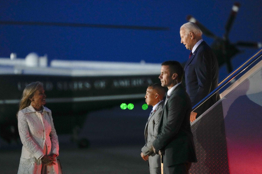 President Joe Biden looks to Jane Hartley, U.S. Ambassador to the United Kingdom, left, as he arrives at Stansted Airport in Stansted, England, Sunday, July 9, 2023. Biden is making a brief stop to visit King Charles III before heading to Lithuania to attend the NATO Summit.