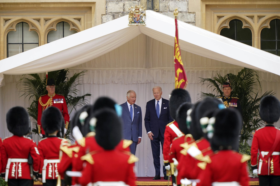 Britain's King Charles III and US President Joe Biden, right, during the welcome ceremony in the quadrangle at Windsor Castle, in Windsor, England, Monday July 10, 2023.