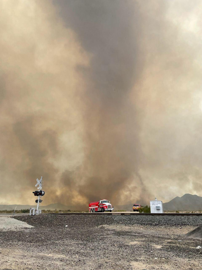 In this photo provided by the National Park Service, smoke rises from the York Fire in the Mojave National Preserve, Calif., Sunday, July 30, 2023. A massive wildfire burning out of control in California's Mojave National Preserve was spreading rapidly amid erratic winds, while firefighters reported progress against another major blaze to the southwest that prompted evacuations.