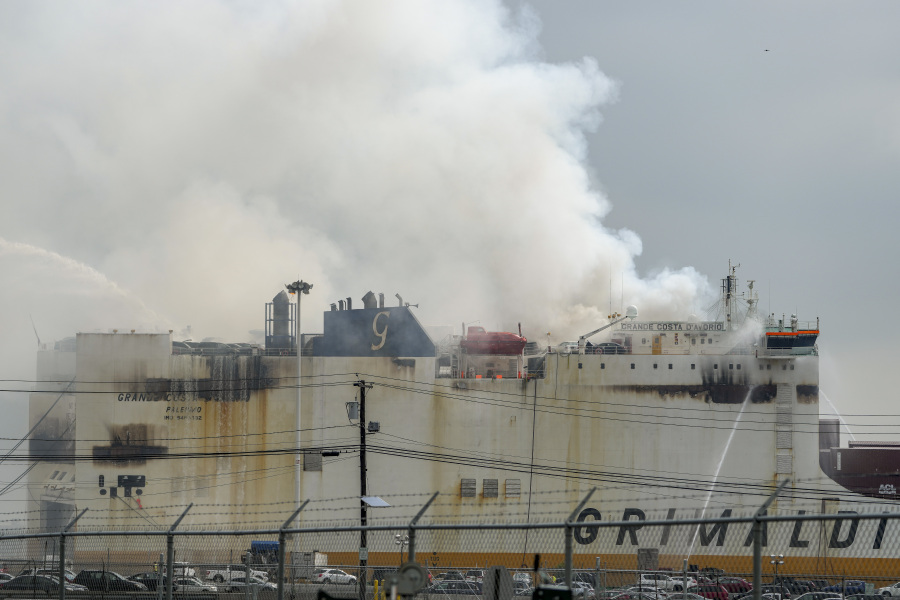 Emergency personnel battle against a fire aboard the Italian-flagged Grande Costa d'Avorio cargo ship at the Port of Newark, Friday, July 7, 2023, in Newark, N.J.  The cargo ship burned for a third day Friday at a New Jersey port after a fire that claimed the lives of two Newark firefighters Augusto "Augie" Acabou and Wayne "Bear" Brooks Jr. , and exposed gaps in the ability of fire crews to respond to emergencies on hulking container ships.