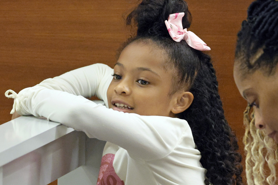 FILE - Olivia Caraballo, 8, is shown in the courtroom gallery after the jury began deliberations at the Broward County Courthouse in Fort Lauderdale on Wednesday, July 19, 2023. The jury awarded $800,000 in damages on Thursday, July 20, 2023, to Caraballo who received second-degree burns in 2019 when a hot McDonald's Chicken McNugget fell on her leg as her mother pulled away from the drive-through of a McDonald's restaurant.