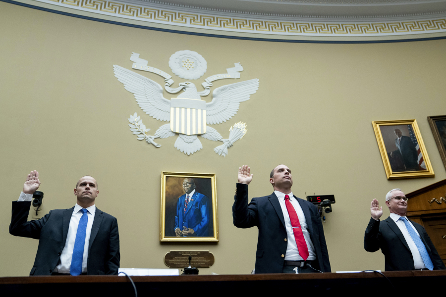 Ryan Graves, Americans for Safe Aerospace Executive Director, from left, U.S. Air Force (Ret.) Maj. David Grusch, and U.S. Navy (Ret.) Cmdr. David Fravor, are sworn in during a House Oversight and Accountability subcommittee hearing on UFOs in the House Rayburn Office building on Wednesday, July 26, 2023 in, Washington.