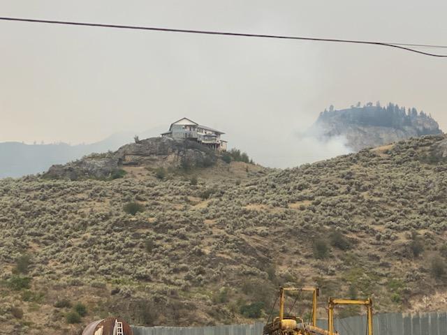 A residence is bypassed by the Eagle Bluff Fire on Sunday.