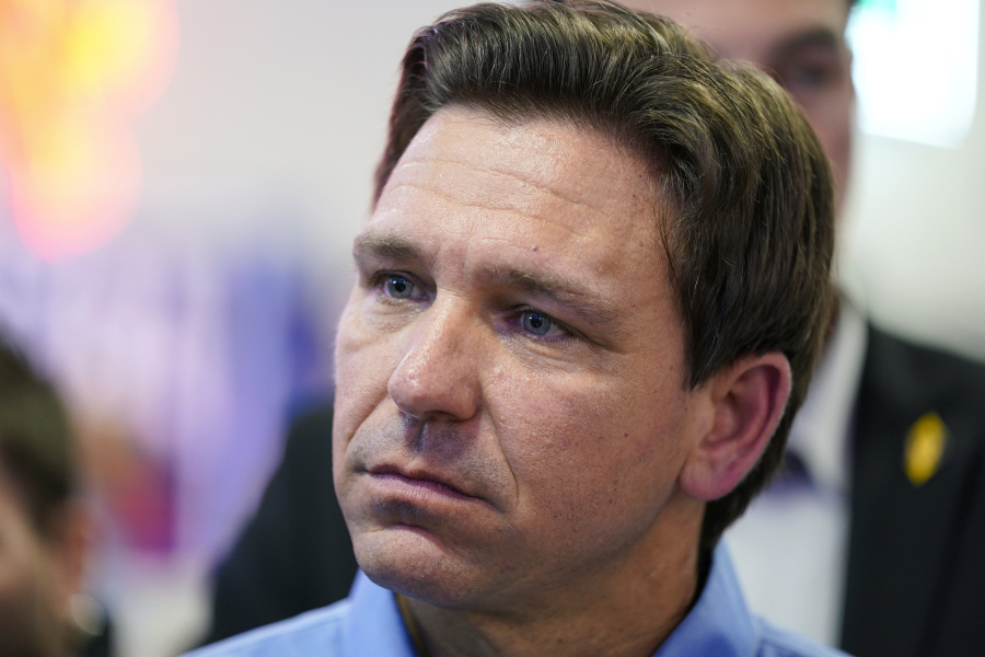FILE - Florida Gov. Ron DeSantis talks with audience members during a fundraising picnic for U.S. Rep. Randy Feenstra, R-Iowa, Saturday, May 13, 2023, in Sioux Center, Iowa. DeSantis is cutting campaign staff as he struggles to catch former President Donald Trump in the GOP's crowded primary contest while facing sudden financial pressure. DeSantis let go fewer than 10 paid staffers late last week. That's according to a DeSantis aide granted anonymity to discuss internal campaign strategy.
