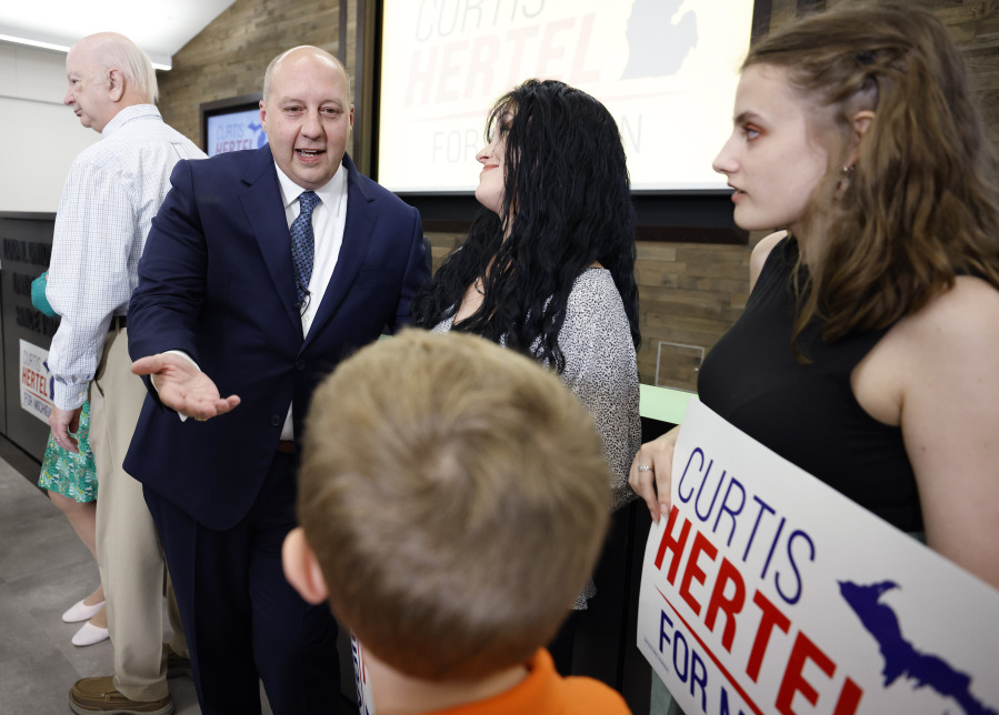 Curtis Hertel Jr., a former Democratic state senator and director of legislative affairs for Gov. Gretchen Whitmer, greets supporters after announcing his run for Michigan's 7th Congressional District, Monday, July 10, 2023 in Lansing, Mich.