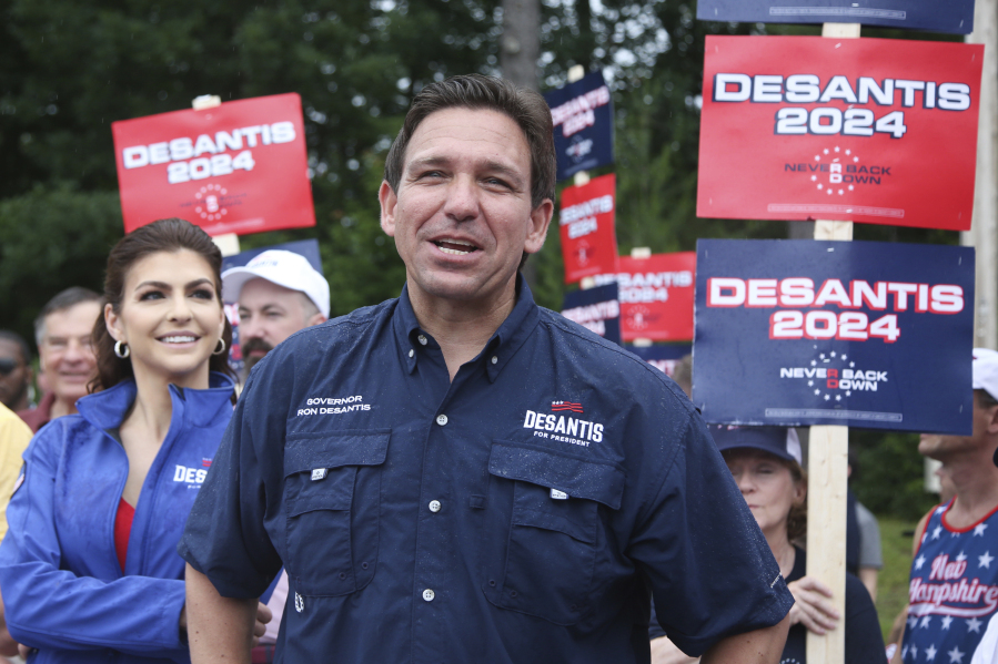 FILE - Republican presidential candidate and Florida Gov. Ron DeSantis and his wife Casey, walk in the July 4th parade, July 4, 2023, in Merrimack, N.H. As the six month sprint to the Iowa caucuses begins, the sprawling field of Republican presidential candidates is facing growing pressure to prove they can become serious challengers to former President Donald Trump.