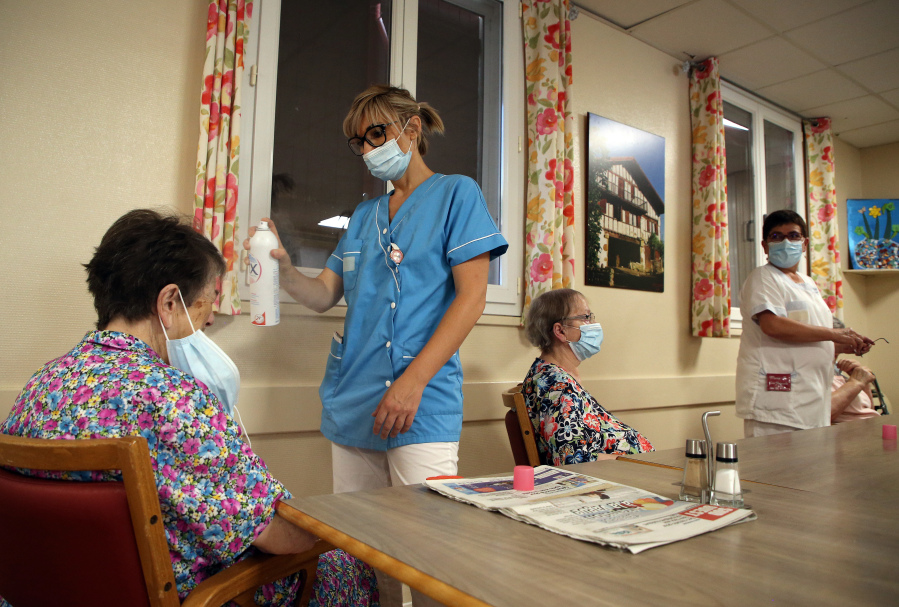 FILE - A health worker refreshes a resident of a retirement home in Isturitz, southwestern France, June 15, 2022. Crushing temperatures that blanketed Europe during the summer of 2022 may have led to more than 61,000 heat-related deaths, according to a study published Monday, July 10, 2023.
