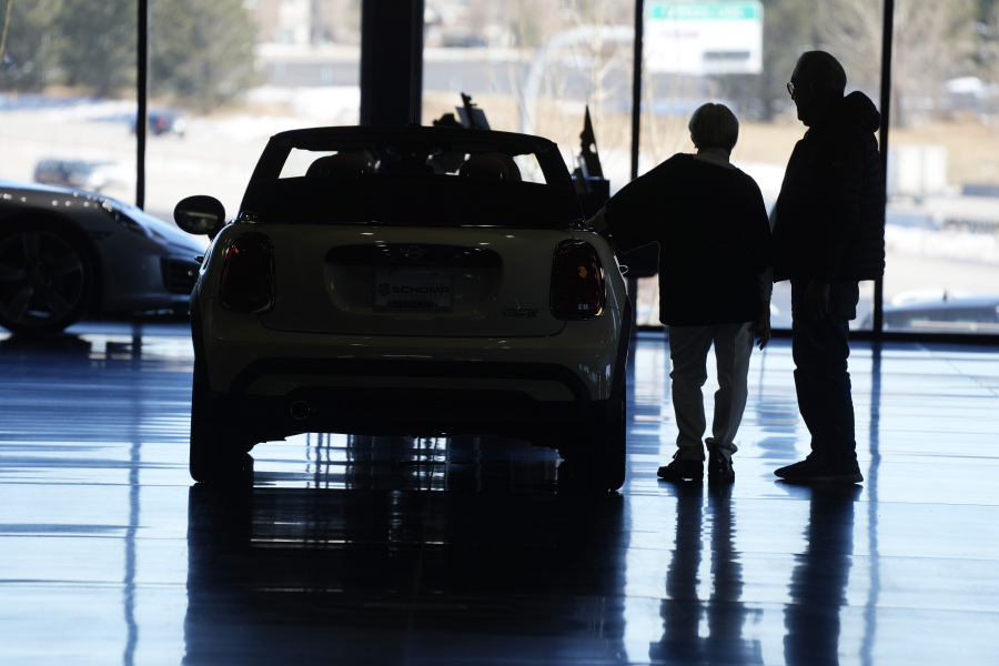 FILE - Shoppers consider a 2022 Cooper convertible on display in a Mini dealership in Highlands Ranch, Colo., on Friday, Feb. 18, 2022.   The Federal Reserve's expected move Wednesday, July 26, 2023, to raise interest rates for the 11th time could once again send ripple effects across the economy.
