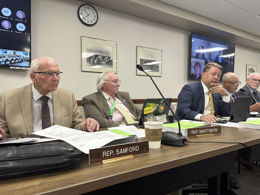 North Dakota Republican state, from left, Reps. Mark Sanford, Bob Martinson and Mike Nathe attend a meeting of the Legislature's Budget Section, Thursday, June 29, 2023, at the state Capitol in Bismarck, N.D. The three lawmakers sit on a panel that wrote the 2023-25 budget for North Dakota's higher education system. Sanford also chairs the Legislature's interim Higher Education Committee, which will be exploring issues of potential impacts from Minnesota's North Star Promise tuition program.
