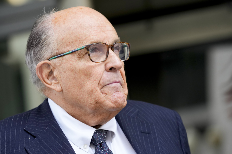FILE - Rudy Giuliani speaks with reporters as he departs the federal courthouse, May 19, 2023, in Washington. Giuliani is not disputing that he publicly made statements about two Georgia election workers that were defamatory and false, but he contends they were constitutionally protected statements, according to a statement filed in court.