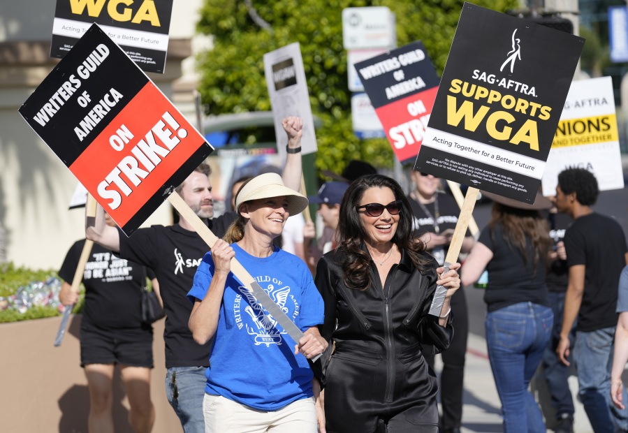 FILE - Meredith Stiehm, left, president of Writers Guild of America West, and Fran Drescher, president of SAG-AFTRA, take part in a rally by striking writers outside Paramount Pictures studio in Los Angeles on May 8, 2023. Hollywood actors may be on the verge of joining screenwriters in what would be the first two-union strike in the industry in more than six decades.