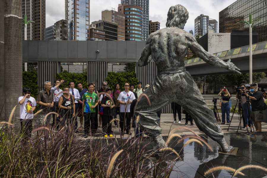 Fans gather in front of the statue of martial artist Bruce Lee to commemorate the 50th anniversary of his death in Hong Kong, Thursday, July 20, 2023.