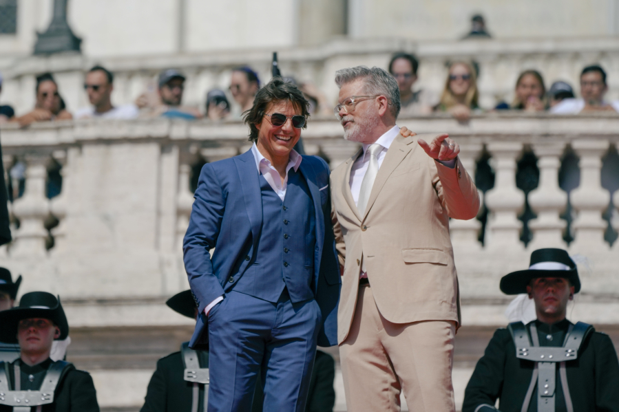 Actor Tom Cruise, left and director Chris McQuarrie pose for photographers on the red carpet of the world premiere for the movie "Mission: Impossible - Dead Reckoning" at the Spanish Steps in Rome on June 19.