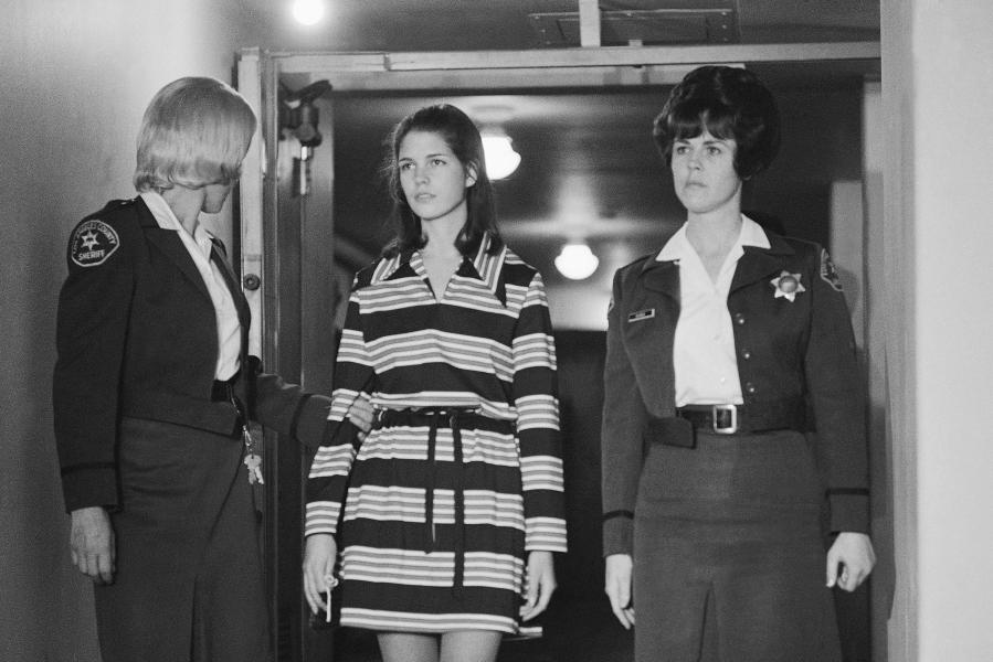 FILE - Leslie Van Houten, 19, a member of Charles Manson's "family" who is charged with the murders of Leno and Rosemary LaBianca, is escorted by two deputy sheriffs as she leaves the courtroom in Los Angeles, Dec. 19, 1969, after a brief hearing. Van Houten has been released from a California prison after serving 53 years for two infamous murders.