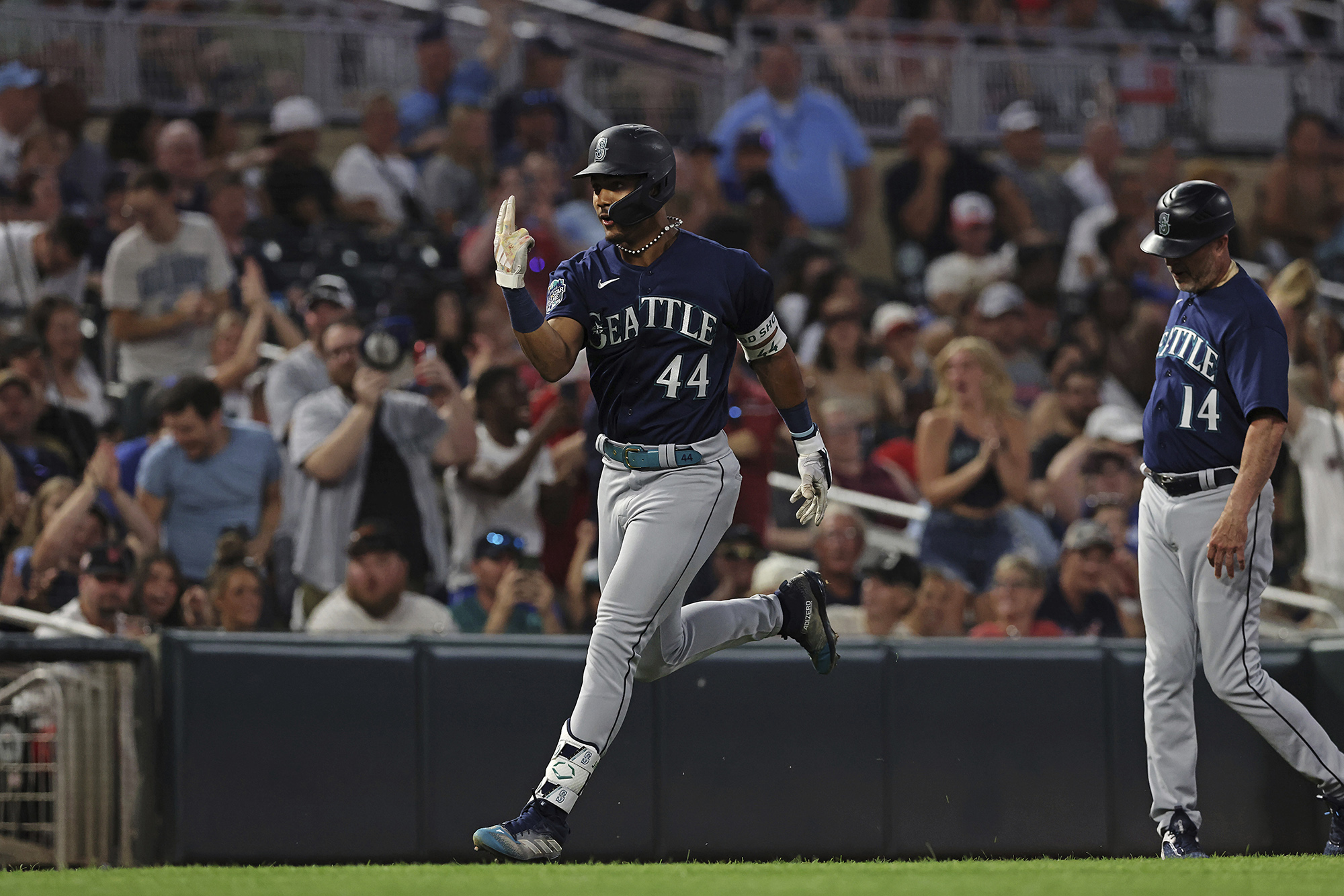 Seattle Mariners' Julio Rodriguez (44) advances toward home base in celebration after hitting a home run during the eighth inning of a baseball game against the Minnesota Twins, Tuesday, July 25, 2023, in Minneapolis.(AP Photo/Stacy Bengs)