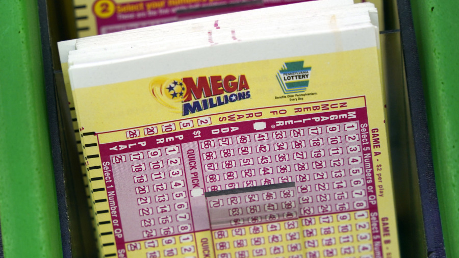 FILE - Mega Millions cards are displayed at the Fuel On Convenience store in Pittsburgh, Jan. 9, 2023. The Mega Millions jackpot has risen to an estimated $720 million after no winning ticket was sold Tuesday, July 18.  The estimated jackpot for the next drawing on Friday, July 21, would be the 7th highest ever in Mega Millions history.  (AP Photo/Gene J.