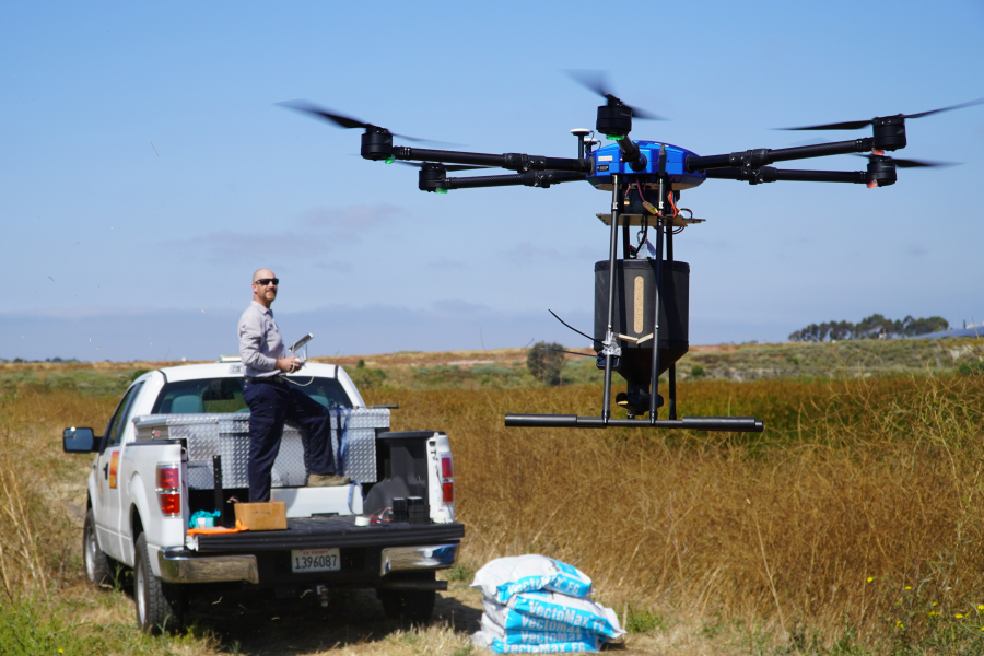 Drone pilot John Savage flies the hexacopter drone loaded with anti-mosquito bacterial spore pellets June 27 at the San Joaquin Marsh Reserve at University of California in Irvine, Calif.