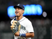 Seattle Mariners center fielder Julio Rodriguez smiles as he jogs off the field in between innings during a baseball game against the Washington Nationals, Tuesday, June 27, 2023, in Seattle.