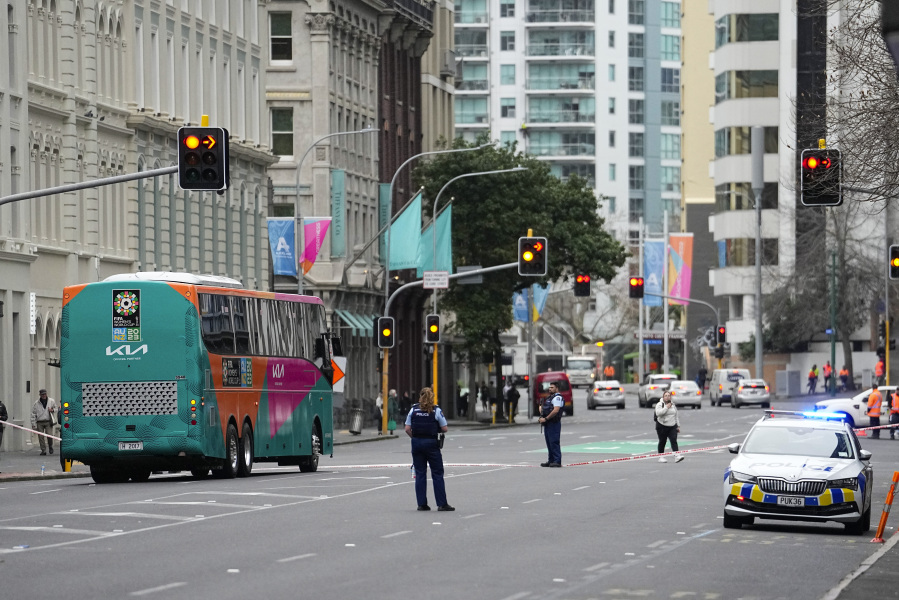 Armed police stand in the street following a shooting in the central business district in Auckland, New Zealand, Thursday, July 20, 2023.