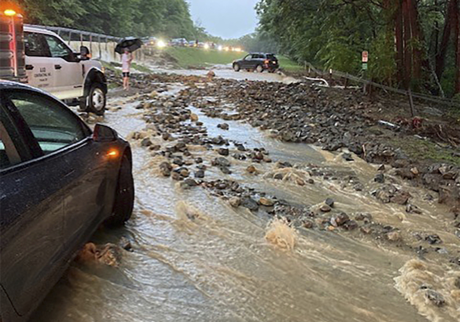 Vehicles come to a standstill near a washed-out and flooded portion of the Palisades Parkway just beyond the traffic circle off the Bear Mountain Bridge, Sunday, July 9, 2023, in Orange County, N.Y. Heavy rain spawned extreme flooding in New York's Hudson Valley that killed at least one person, swamped roadways and forced road closures on Sunday night, as much of the rest of the Northeast U.S. geared up for a major storm.