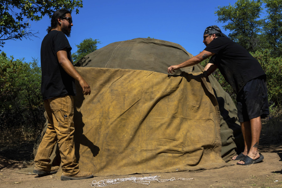 Men work to build a sweat lodge June 3 on Oak Flat Campground, a sacred site for Native Americans, in Miami, Ariz. Resolution Copper Mining, a joint subsidiary of British and Australian mining giants, Rio Tinto and BHP, has proposed a massive copper mine on the flats.