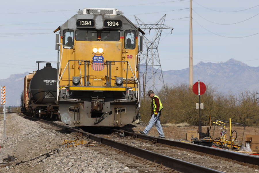 FILE - The crew on a Union Pacific freight train works at a siding area, Jan. 24, 2020, south of Tucson, Ariz. Union Pacific will renew its push for one-person train crews later this summer when the railroad tests out the idea of having a conductor in a truck respond to problems on trains in Nebraska and Colorado. UP's Jason Pinder confirmed the pilot program on Monday, July 17, 2023, when he testified against a proposed Kansas rule that would require two-person crews.
