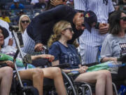New York Yankees manager Aaron Boone, center, talk with Sarah Langs, their HOPE Week honoree, on the 84th anniversary of Lou Gehrig making his famous "Luckiest Man" speech, Tuesday, July 4, 2023, in New York. Langs, one of Major League Baseball's most respected and universally liked statistical analysts, has been in a battle with ALS the last three years. Langs and women from the organization "Her ALS Story" made a pregame tour of Monument Park and the Yankees Museum.