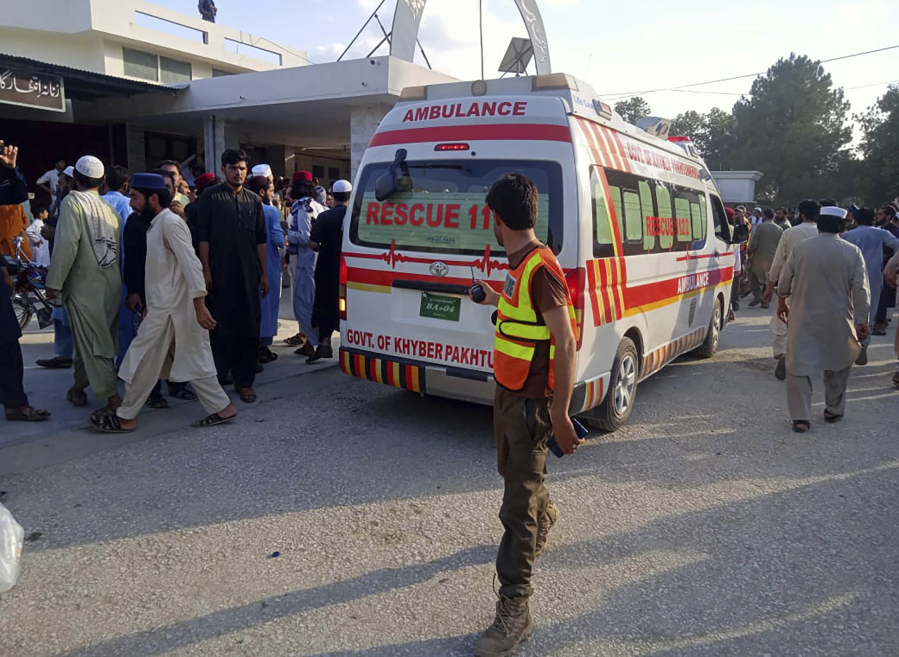 In this photo provided by Rescue 1122 Head Quarters, an ambulance carries injured people after a bomb explosion in the Bajur district of Khyber Pakhtunkhwa, Pakistan, Sunday, July 30, 2023. A powerful bomb ripped through a rally by supporters of a hard-line cleric and political leader in the country's northwestern Bajur district that borders Afghanistan on Sunday, killing at least 10 people and wounding more, police said.