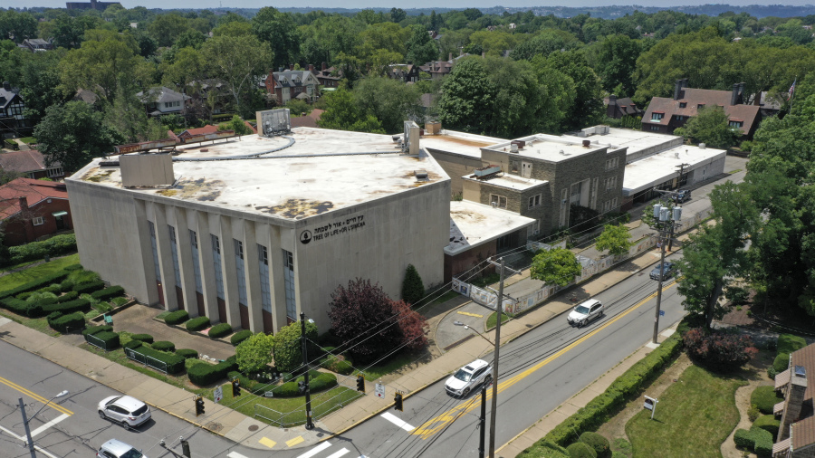 This photo taken with a drone shows the Tree of Life Synagogue, left, in the Squirrel Hill neighborhood of Pittsburgh on Thursday, July 13, 2023, the day a federal jury announced they had found Robert Bowers, who in 2018 killed 11 people at the synagogue, eligible for the death penalty. (AP Photo/Gene J.