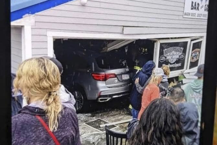 In this photo released by the Laconia Fire Department, a vehicle sits inside a restaurant after crashing through the wall on Sunday, July 2, 2023, in Laconia, NH. The car struck the busy Looney Bin Bar & Grill and injured more than a dozen patrons inside, authorities said.