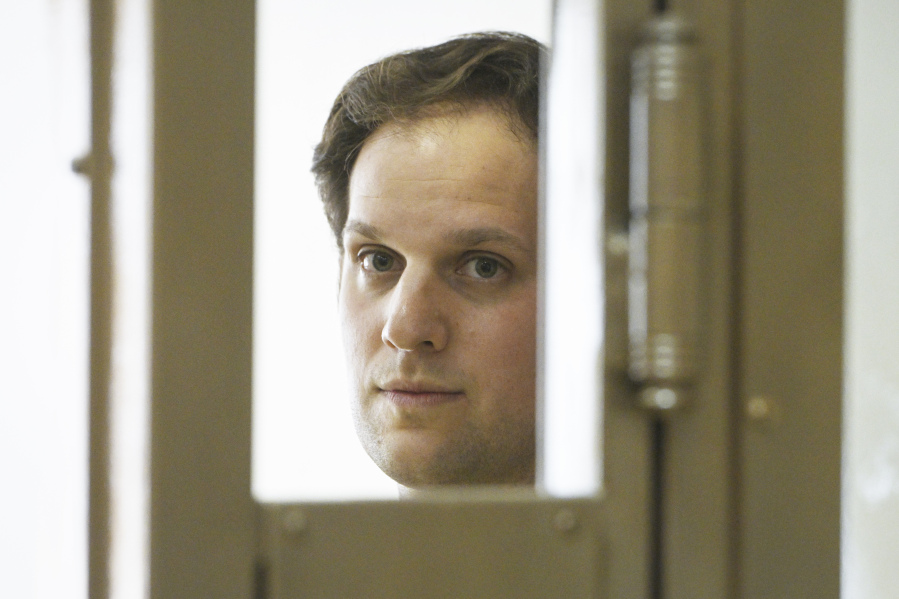 Wall Street Journal reporter Evan Gershkovich stands in a glass cage in a courtroom at the Moscow City Court in Moscow, Russia, Thursday, June 22, 2023. Gershkovich, a reporter detained on espionage charges in Russia, appeared in court Thursday to appeal his extended detention.
