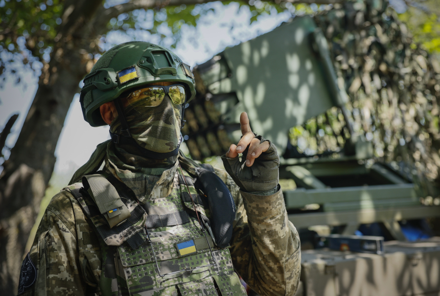 A Ukrainian soldier gestures as he prepares a Croatian RAK-SA-12 128mm multiple rocket launcher to fire towards the Russian positions on the frontline near Bakhmut in the Donetsk region, Ukraine, Monday, July 10, 2023.