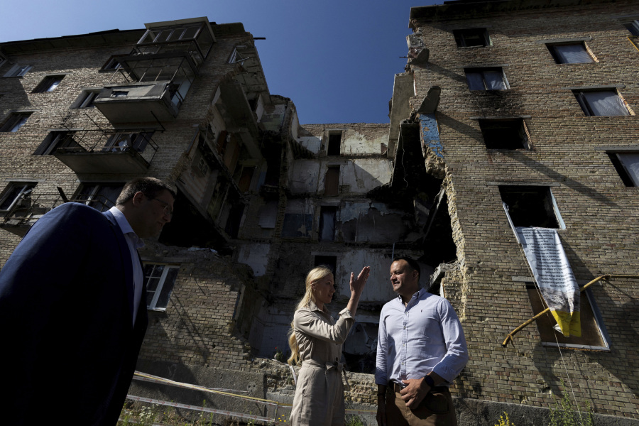 Ireland's Prime Minister Leo Varadkar, right, checks destroyed buildings in Moschun, outside of Kyiv, Ukraine, Wednesday July 19, 2023.