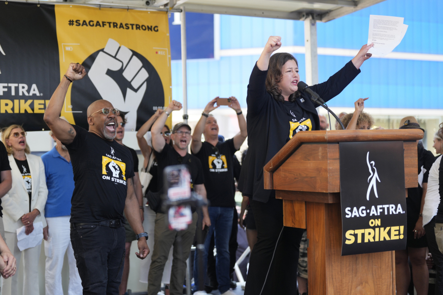 Actor Rebecca Damon speaks during the SAG-AFTRA "Rock the City for a Fair Contract" rally in Times Square on Tuesday, July 25, 2023, in New York. The actors strike comes more than two months after screenwriters began striking in their bid to get better pay and working conditions.