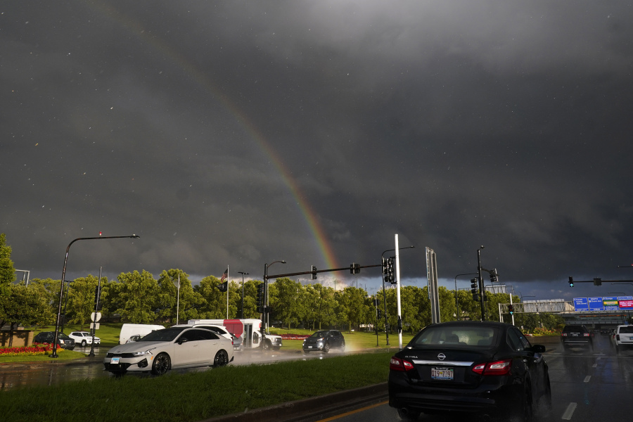 A rainbow arches over the road Wednesday near Midway International Airport in Chicago following severe weather. (nam y.