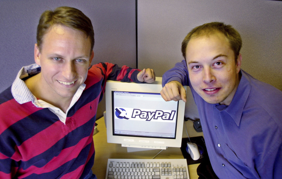 FILE - PayPal Chief Executive Officer Peter Thiel, left, and founder Elon Musk, right, pose with the PayPal logo at corporate headquarters in Palo Alto, Calif., Oct. 20, 2000.    Musk may want to send "tweet" back to the birds, but the ubiquitous term for posting on the site he now calls X is here to stay, at least for now.  For one, the word is still plastered all over the website formerly known as Twitter. Write a post, you still need to press a blue button that says "tweet" to publish it.