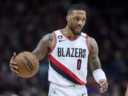 FILE - Portland Trail Blazers guard Damian Lillard brings the ball up against the New York Knicks during the second half of an NBA basketball game in Portland, Ore., Tuesday, March 14, 2023.