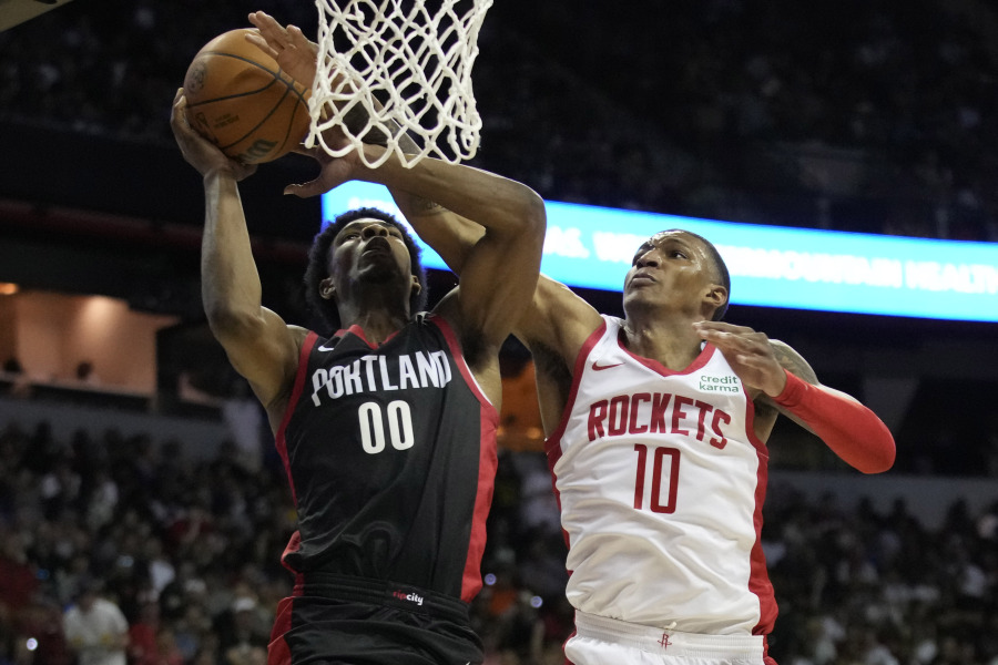 Houston Rockets' Jabari Smith Jr., right, fouls Portland Trail Blazers' Scoot Henderson during the second half of an NBA summer league basketball game Friday, July 7, 2023, in Las Vegas.