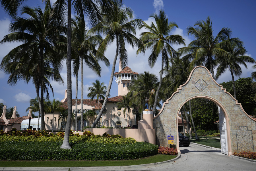 FILE - A security car blocks the drive at the entrance to former President Donald Trump's Mar-a-Lago estate in Palm Beach, Fla., March 29, 2023. An employee of Donald Trump's Mar-a-Lago estate, Carlos De Oliveira, is expected to make his first court appearance Monday, July 31, on charges accusing him of scheming with the former president to hide security footage from investigators probing Trump's hoarding of classified documents.