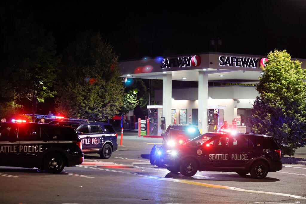 Seattle police cars sit outside the Rainier Beach Safeway after a shooting on July 28, 2023, in Seattle.