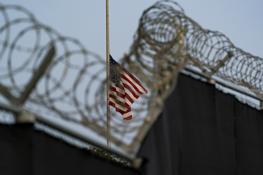 FILE - In this photo reviewed by U.S. military officials, a flag flies at half-staff in honor of the U.S. service members and other victims killed in the terrorist attack in Kabul, Afghanistan, as seen from Camp Justice in Guantanamo Bay Naval Base, Cuba, Aug. 29, 2021. The first U.N. independent investigator to visit the U.S. detention center at Guantanamo Bay said Monday, June 26, 2023, that the 30 men held there are subject "to ongoing cruel, inhuman and degrading treatment under international law." The U.S. response said Irish law professor Fionnuala N? Aol?in was the first U.N.