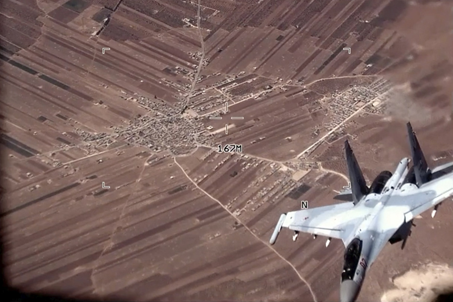 In this image from video released by the U.S. Air Force, a Russian SU-35 flies near a U.S. Air Force MQ-9 Reaper drone on Wednesday, July 5, 2023, over Syria. The U.S. Air Force says Russian fighter jets flew dangerously close to several U.S. drone aircraft over Syria, setting off flares and forcing the MQ-9 Reapers to take evasive maneuvers. (U.S.