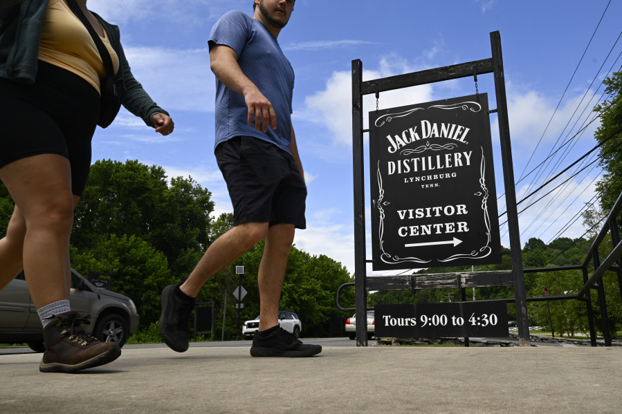 Visitors walk to the Jack Daniels Distillery visitor center Wednesday, June 14, 2023, in Lynchburg, Tenn. A destructive and unsightly black fungus which feeds on ethanol emitted by whiskey barrels has been found growing on property near the distillery's barrelhouses.