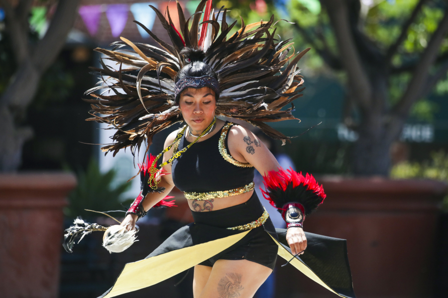 Feathers are used in the garb of Aztec dancers such as the Xipe Totec group; one of the company???s dancers performs on Olvera Street in Los Angeles.