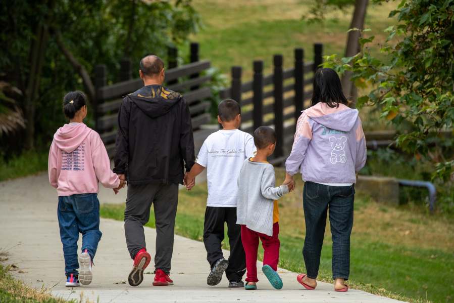 Shidong Liang, second from left, walks with his wife and three children, ages 6, 7 and 10, at Peter F. Schabarum Regional Park in Rowland Heights on June 15. The family reached the Los Angeles area on June 6 after a journey that included crossing the dangerous Darien Gap.