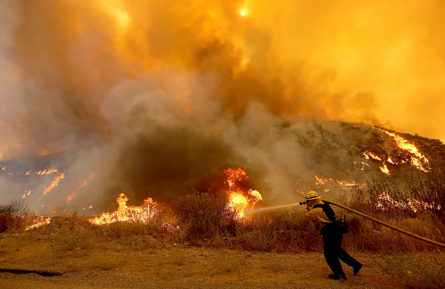 A firefighter battles the Fairview fire along Batista Road near Hemet, California, on Sep. 6, 2022.