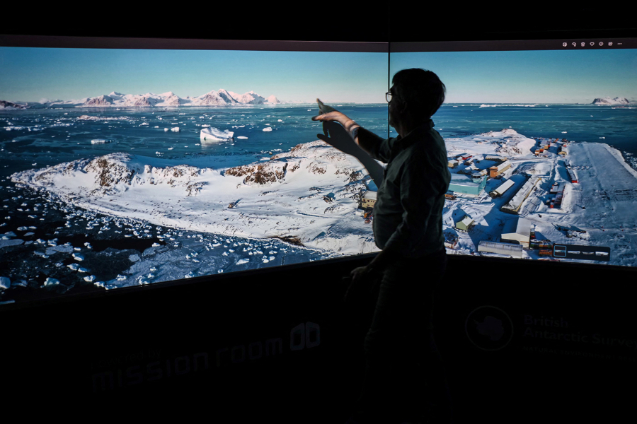 A professor of the British Antarctic Survey shows a picture of one of the bases in the Antarctic region of Polar Science for a Sustainable Planet, during a visit of the British Antarctic Survey's headquarters in Cambridge, on June 19, 2023, for the launch of the new 10-year BAS science strategy. With research stations transferring to renewable energy and artificial intelligence mapping out fuel-efficient marine routes, the British Antarctic Survey is putting sustainability at the heart of its new 10-year plan.