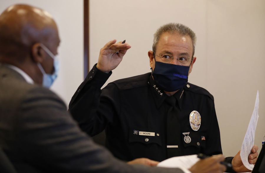 LAPD Chief Michel Moore talks with Los Angeles Police Commissioner Dale Bonner at police headquarters in 2021.